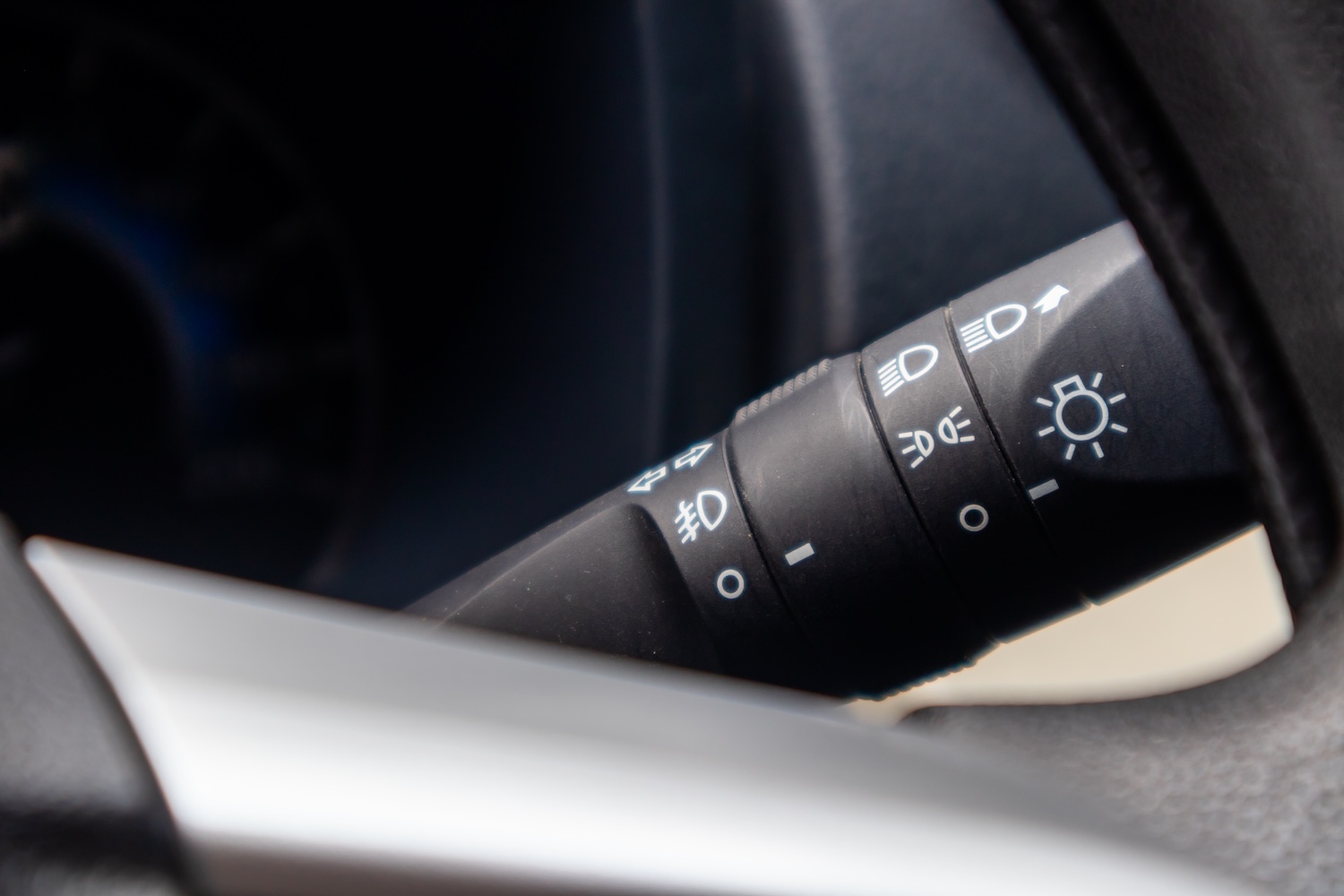 a used headlight control switch installed in a car