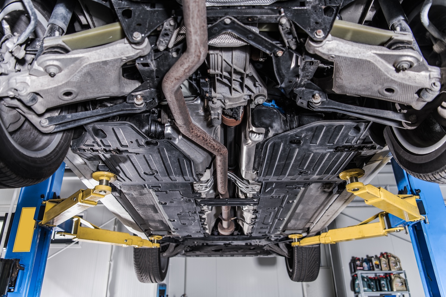 A car on lift repair as its having a drive shaft replacement fitted