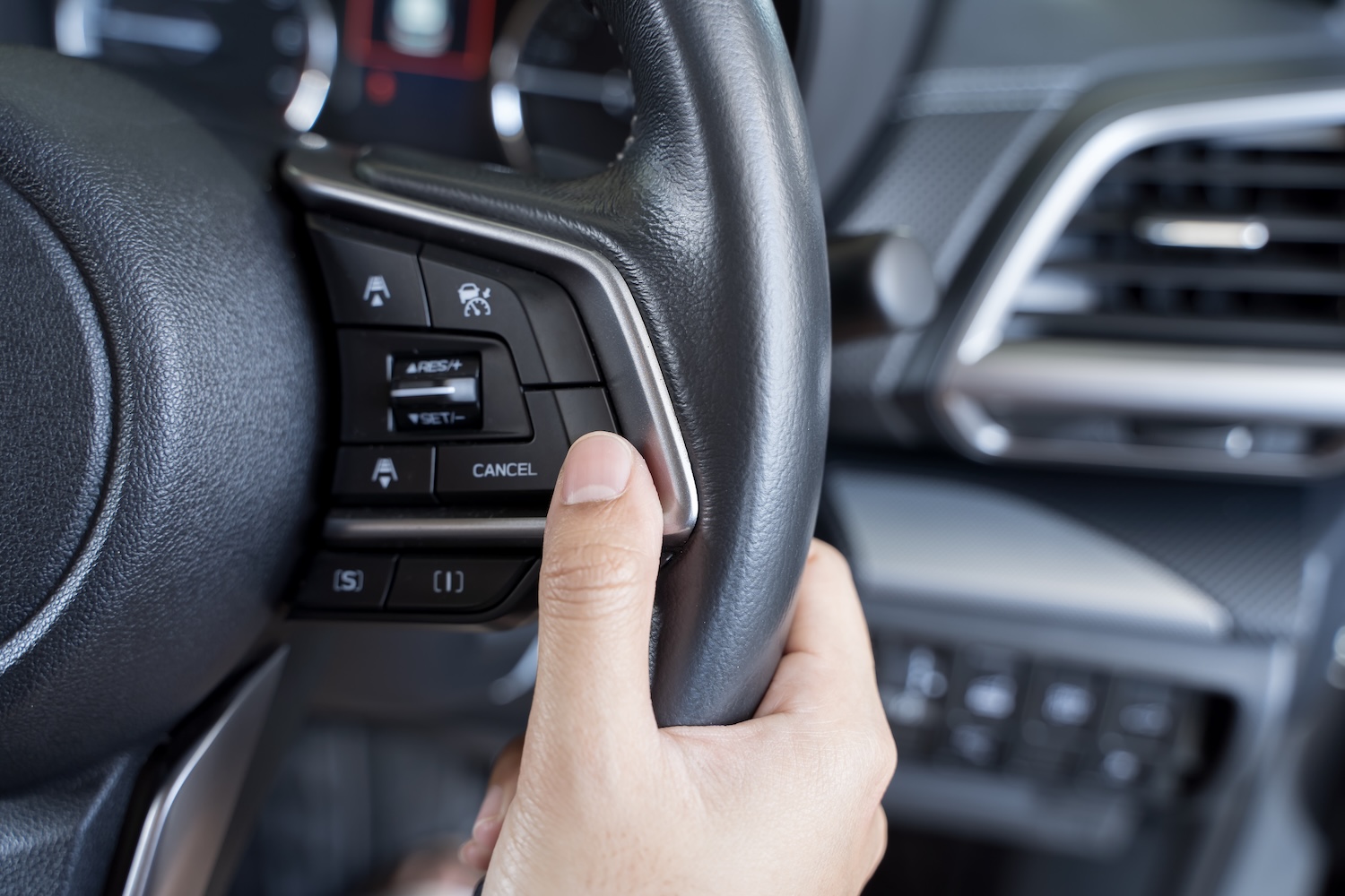 A man holding a steering wheel that is working because of a steering wheel clock spring replacement